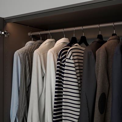 A wardrobe with led lights illuminating clothes on hangers. The lights automatically turn on and off with the door.