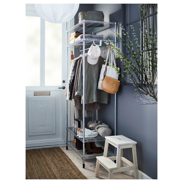 Hallway setup with OMAR silver metal shelving, clothing, purse, and plant.