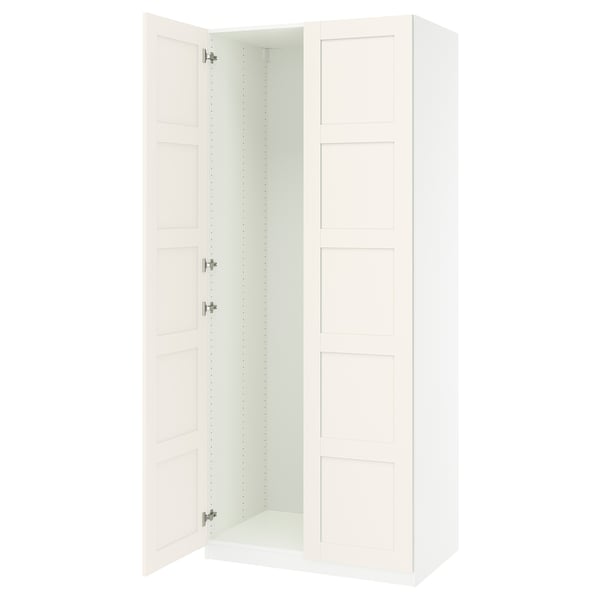 An open white PAX wardrobe with adjustable shelves and soft-closing hinges.