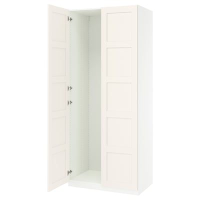 An open white PAX wardrobe with adjustable shelves and soft-closing hinges.