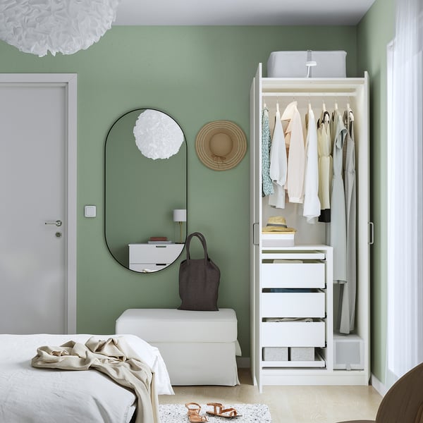 Bedroom with PAX wardrobe, mirror doors, hanging clothes, drawers, and a divider for long garments.