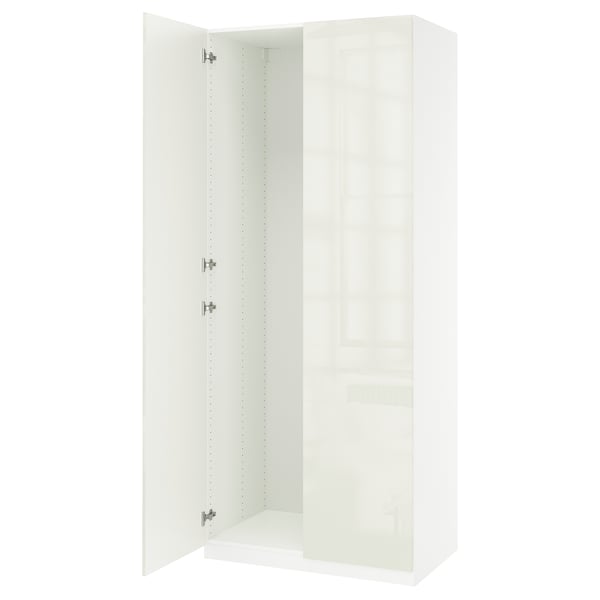 A white PAX wardrobe with a sleek design and adjustable feet.
