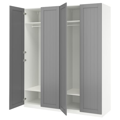 An open grey IKEA PAX wardrobe with shelves and a hanging rod.