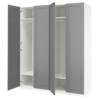 An open grey IKEA PAX wardrobe with shelves and a hanging rod.