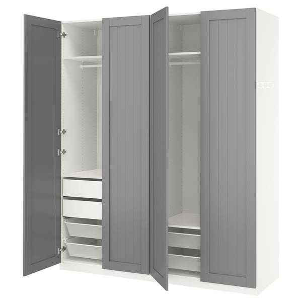 Grey PAX wardrobe with open doors, white interior, shelves, drawers, mesh baskets, and soft-close hinges.