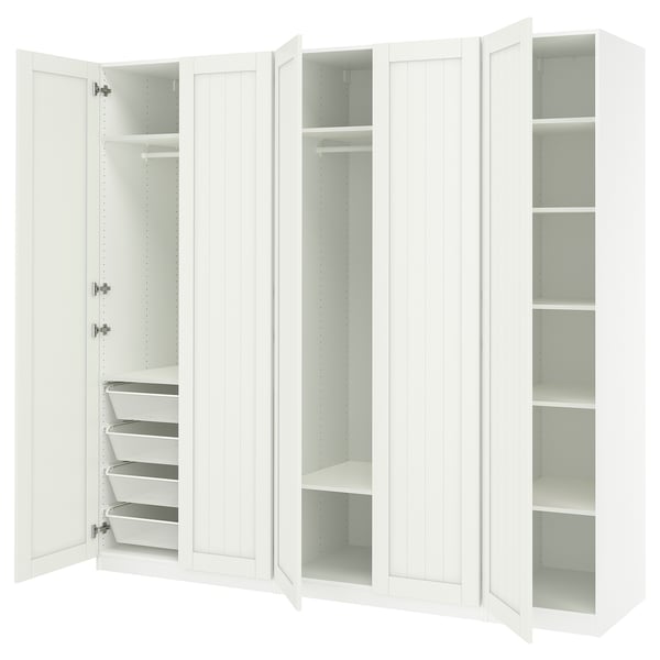 A white PAX wardrobe with open doors, revealing shelves and storage baskets inside.