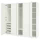 A white PAX wardrobe with open doors, revealing shelves and storage baskets inside.