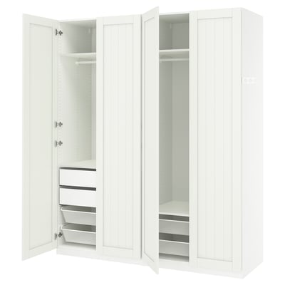A white PAX wardrobe with open doors, revealing shelves, drawers, and mesh baskets inside.
