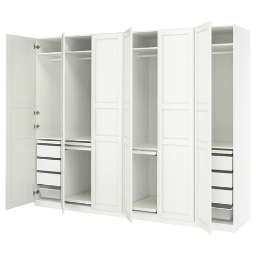 White PAX wardrobe, open doors showing shelves and drawers. Modern, minimalist design with adjustable interiors.