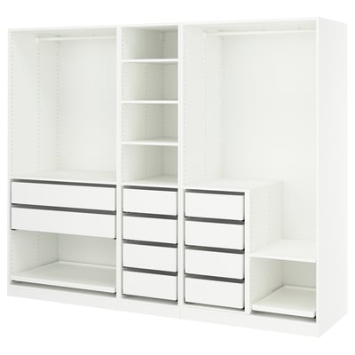 White PAX wardrobe system by IKEA, open design with shelves and drawers.