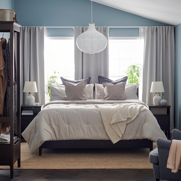 Blue bedroom, large bed, window, closets.