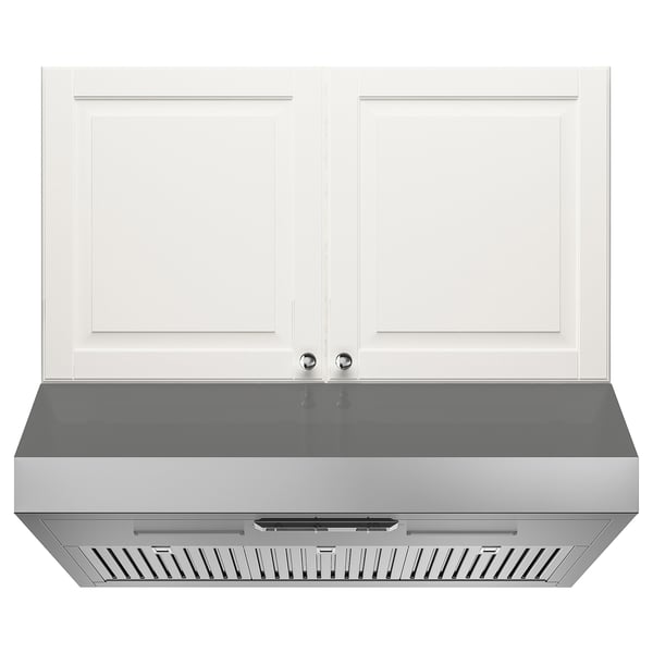Stainless steel range hood with led lights, under white cabinets.