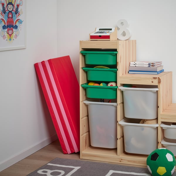 Kids playroom with PLUFSIG mat for practising acrobatics. Wooden storage with colourful bins holds books and toys.