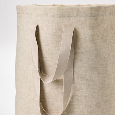 Large beige laundry tote with reinforced handles and drawstring closure.