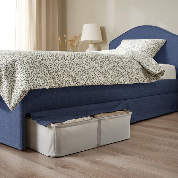 Bed with removable, washable cover, padded headboard, and storage under skirt.