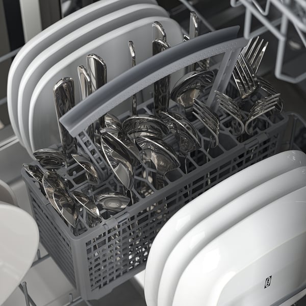 Compact dishwasher with adjustable racks holding shiny cutlery.