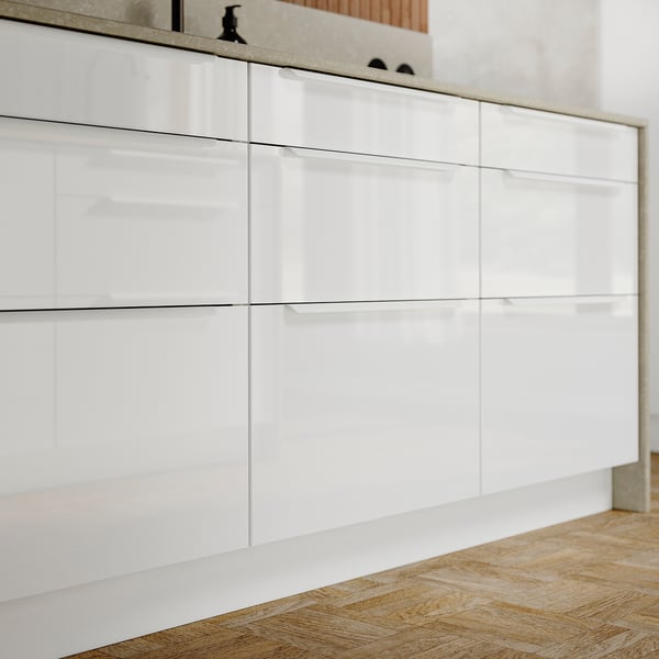 High gloss white RINGHULT kitchen cabinets with sleek modern design.