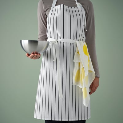 Person in striped white apron, holding bowl and towel, kitchen clean design.