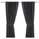 Two dark grey RITVA curtains hang straight with rod pockets and tiebacks. Made from 100% cotton, they provide privacy and light control.