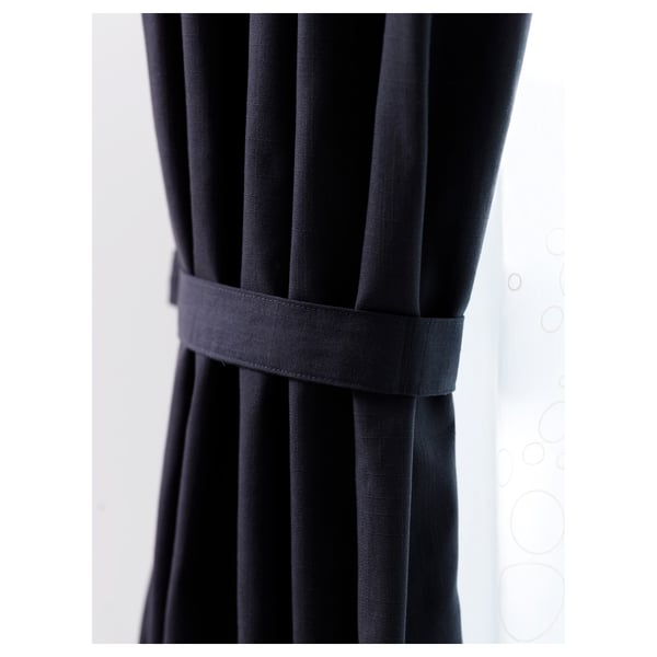 Black RITVA cotton curtain with grey tie-back, hanging straight.