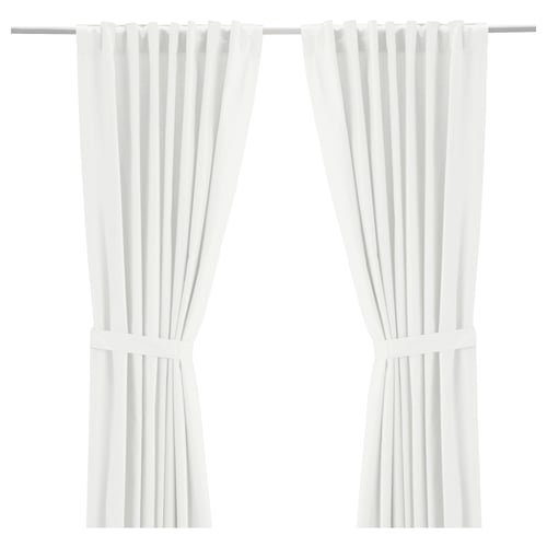 Two white RITVA curtains with flat panels and rod pockets, made of 100% cotton, tied back.