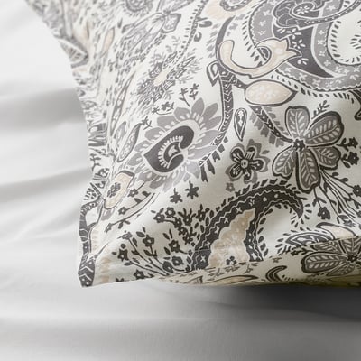 Decorative pillowcase with intricate paisley print, soft cotton-viscose blend, featuring envelope closure, resting on bed.