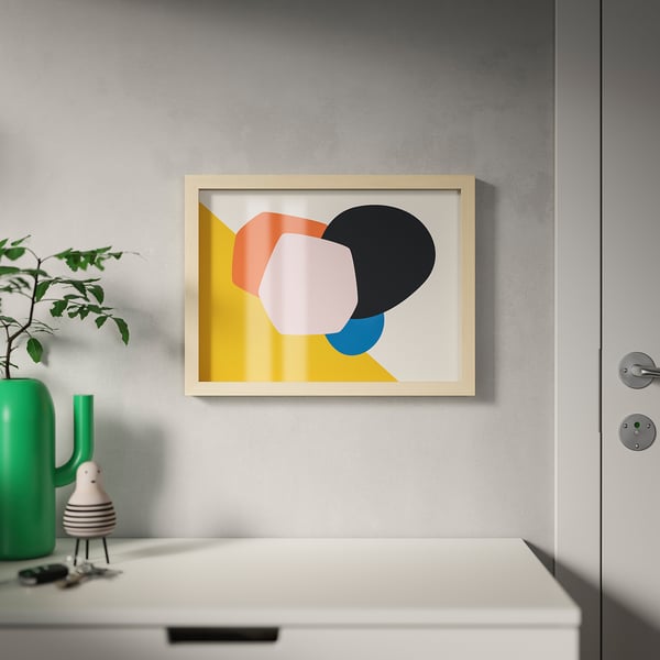 Vibrant abstract painting, wooden frame, grey wall, white drawer, green plant vase, pastel & bright colours.