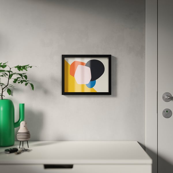 Abstract art on grey wall above white cabinet with green vase and figurine.