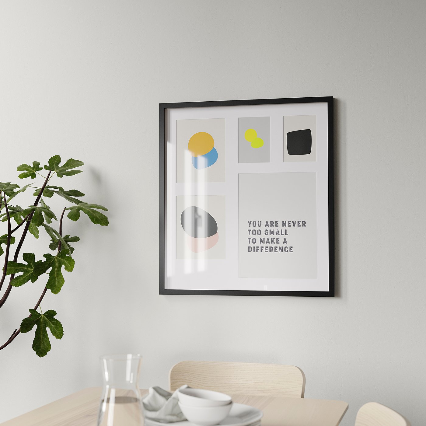 Framed motivational poster on wall above dining table, plant to left, glass and bowl in foreground.