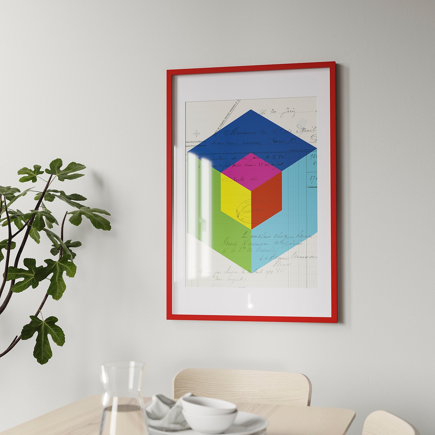 Picture frame on wall, vibrant multi-colored geometric art, with red frame, near dining setup with plant and cups.