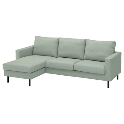 A light green SALTSJÖBADEN sofa with a chaise lounge. It has a modern design with dark metal legs and plush cushions.