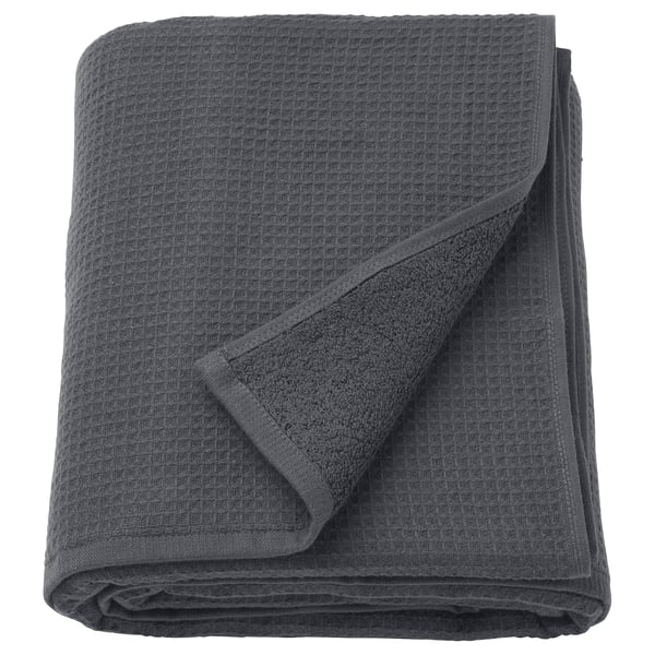 A folded grey SALVIKEN towel featuring a waffle texture on one side and soft terry on the other.