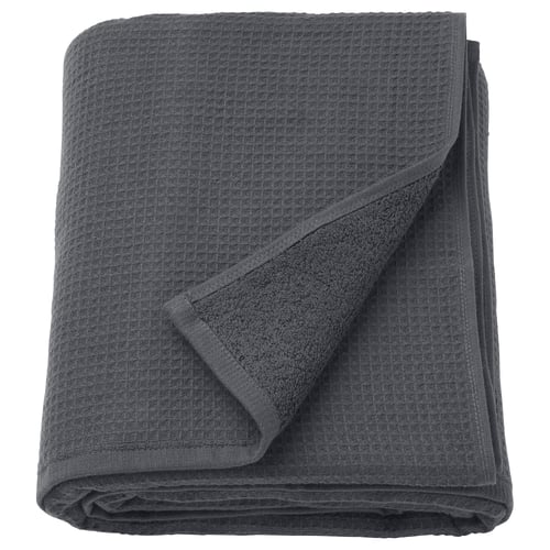 A folded grey SALVIKEN towel featuring a waffle texture on one side and soft terry on the other.