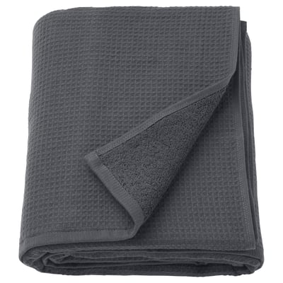 A folded grey SALVIKEN towel featuring a waffle texture on one side and soft terry on the other.