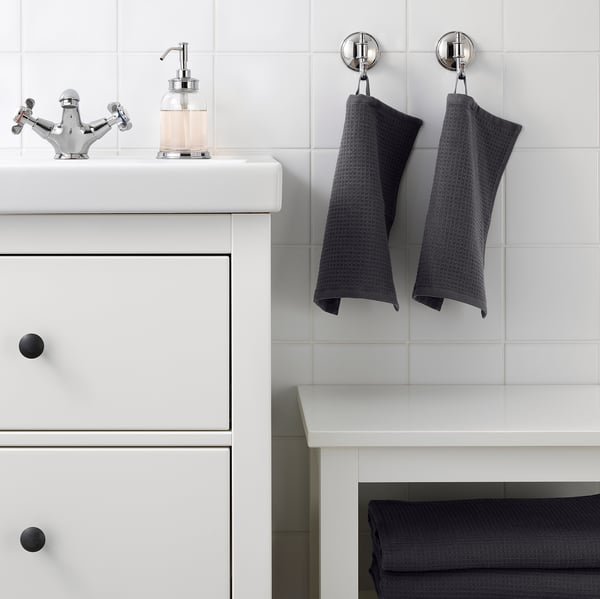 Modern bathroom with white vanity, chrome tap, and SALVIKEN towels.