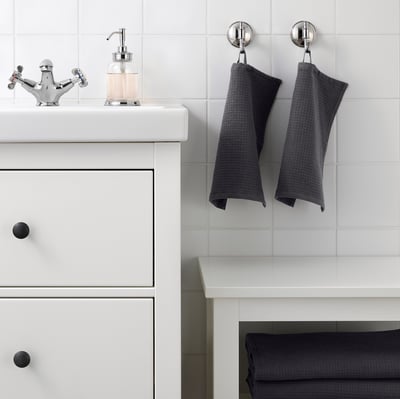 Modern bathroom with white vanity, chrome tap, and SALVIKEN towels.