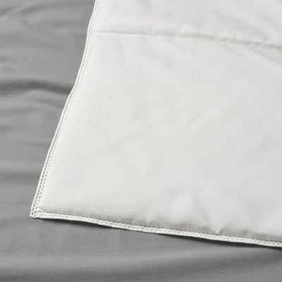 Close-up of a neatly stitched, smooth, white duvet cover, showcasing its fine quality and craftsmanship.