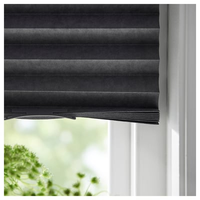 Dark grey SCHOTTIS blind, partially open, on white window, made of recycled polyester.