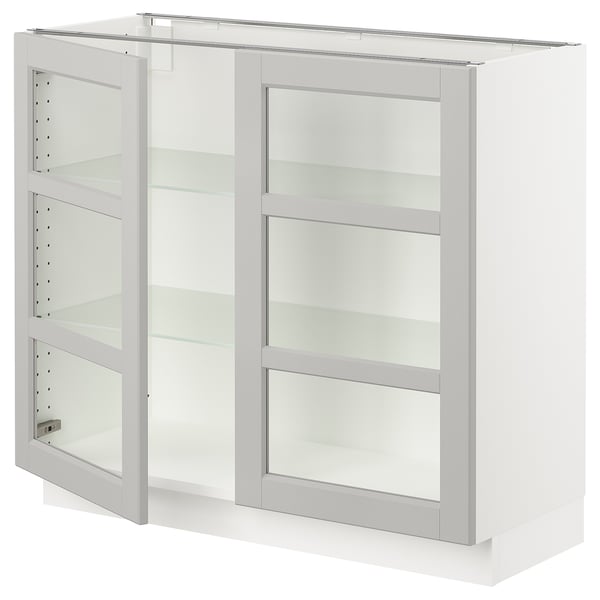 This image shows a white ikea SEKTION kitchen cabinet with glass doors and adjustable shelves.