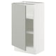 A SEKTION kitchen cabinet in light grey with a modern design. It a single door with two adjustable shelves inside.
