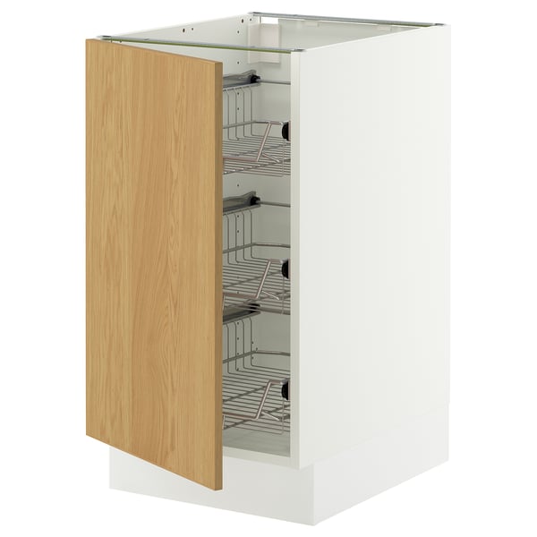 A white ikea SEKTION kitchen cabinet with a light oak door open, revealing wire shelves inside.