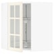 An open white SEKTION corner cabinet with glass doors featuring bevelled edges, revealing adjustable shelves inside.