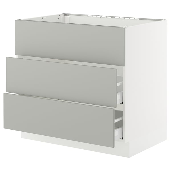 A white SEKTION kitchen cabinet with three light grey drawers. It has a modern, clean design with a smooth finish.