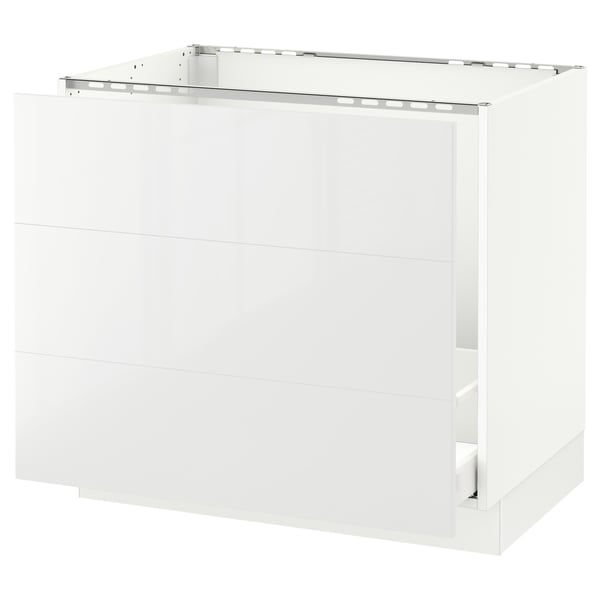 A white SEKTION kitchen cabinet with a glossy finish and a three-drawer design. It has a sleek, modern look.