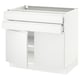 Modern white kitchen unit with sleek design and integrated handles.