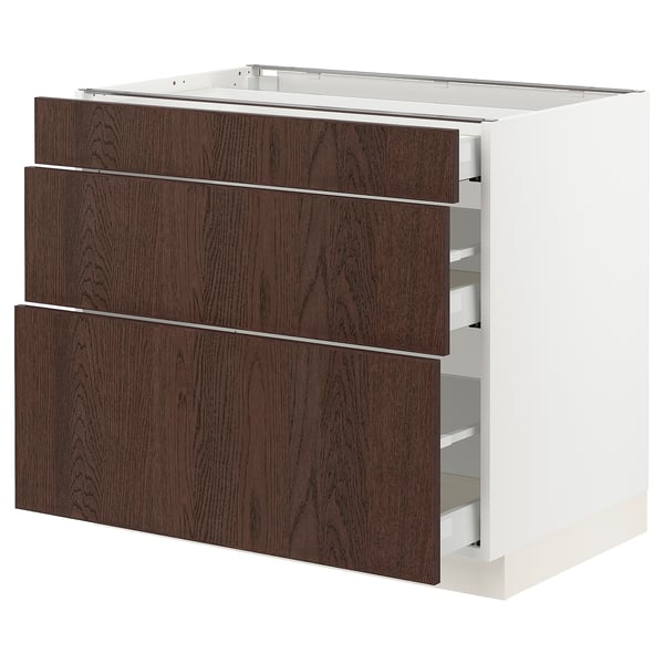 An ikea kitchen cabinet named SEKTION with dark brown sinarp drawers featuring solid wood edges. It has three drawers with soft-close mechanisms.