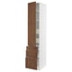 A tall white ikea SEKTION kitchen cabinet with wooden drawers and a door in walnut finish. It both drawers and shelves.