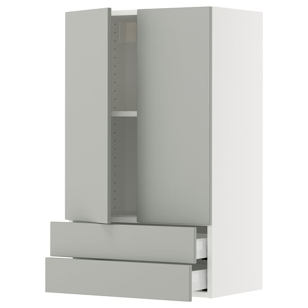 A SEKTION kitchen cabinet in light grey with drawers and shelves. The cabinet is modern and minimalist, with a clean design and metallic handles.