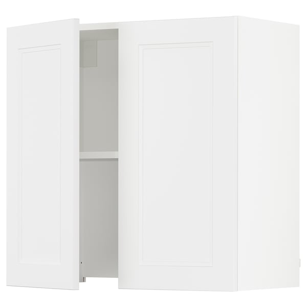 A white SEKTION kitchen cabinet with one door open revealing an adjustable shelf.