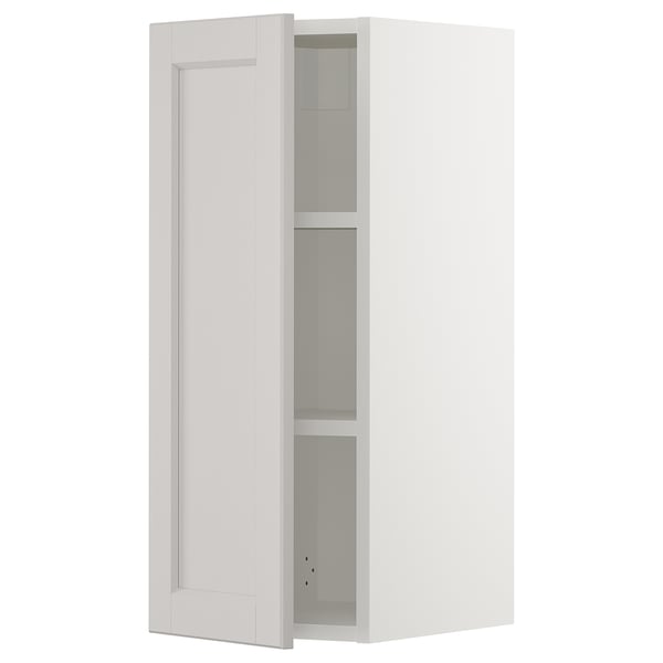 White SEKTION kitchen cabinet with adjustable shelves and bevelled edges.